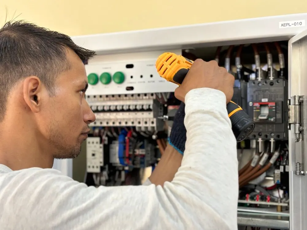 Électricien intervenant sur un tableau électrique